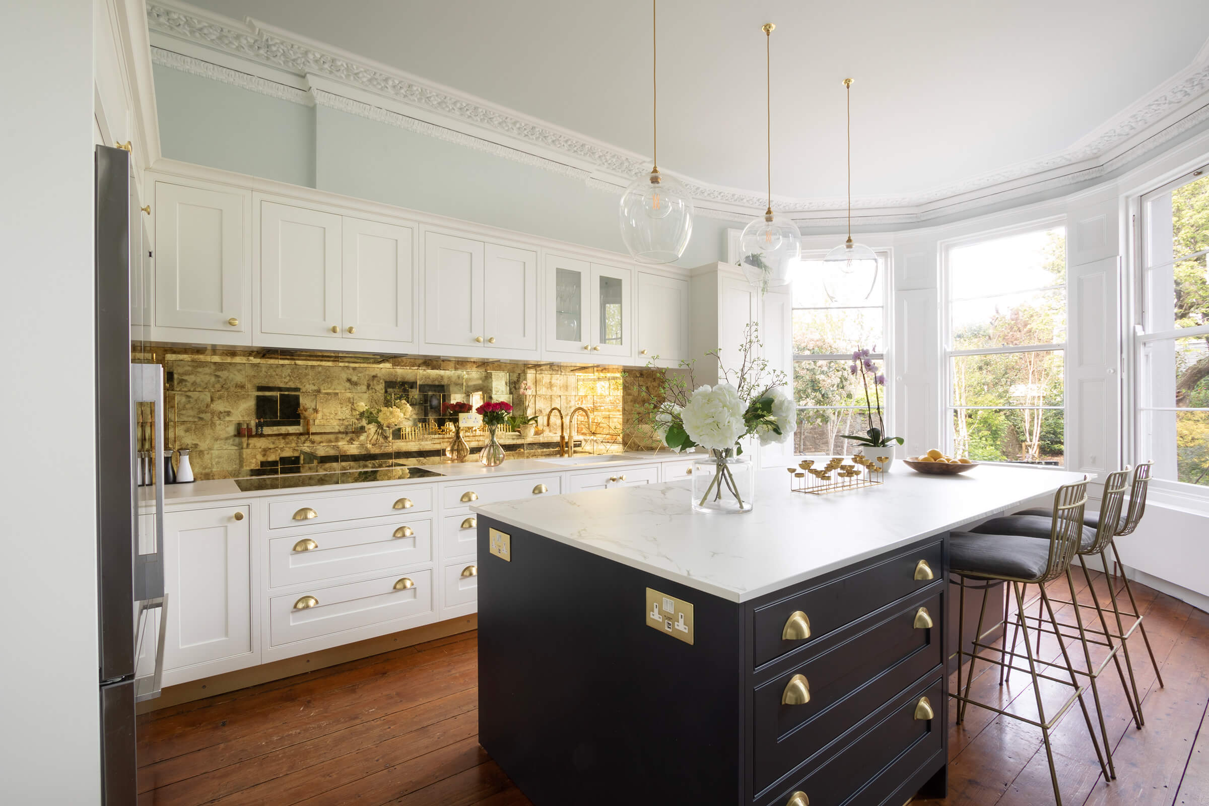 Elegant Shaker-Style Kitchen with Marble Island and Brass Accents: A Partnership with The Kitchen Partners