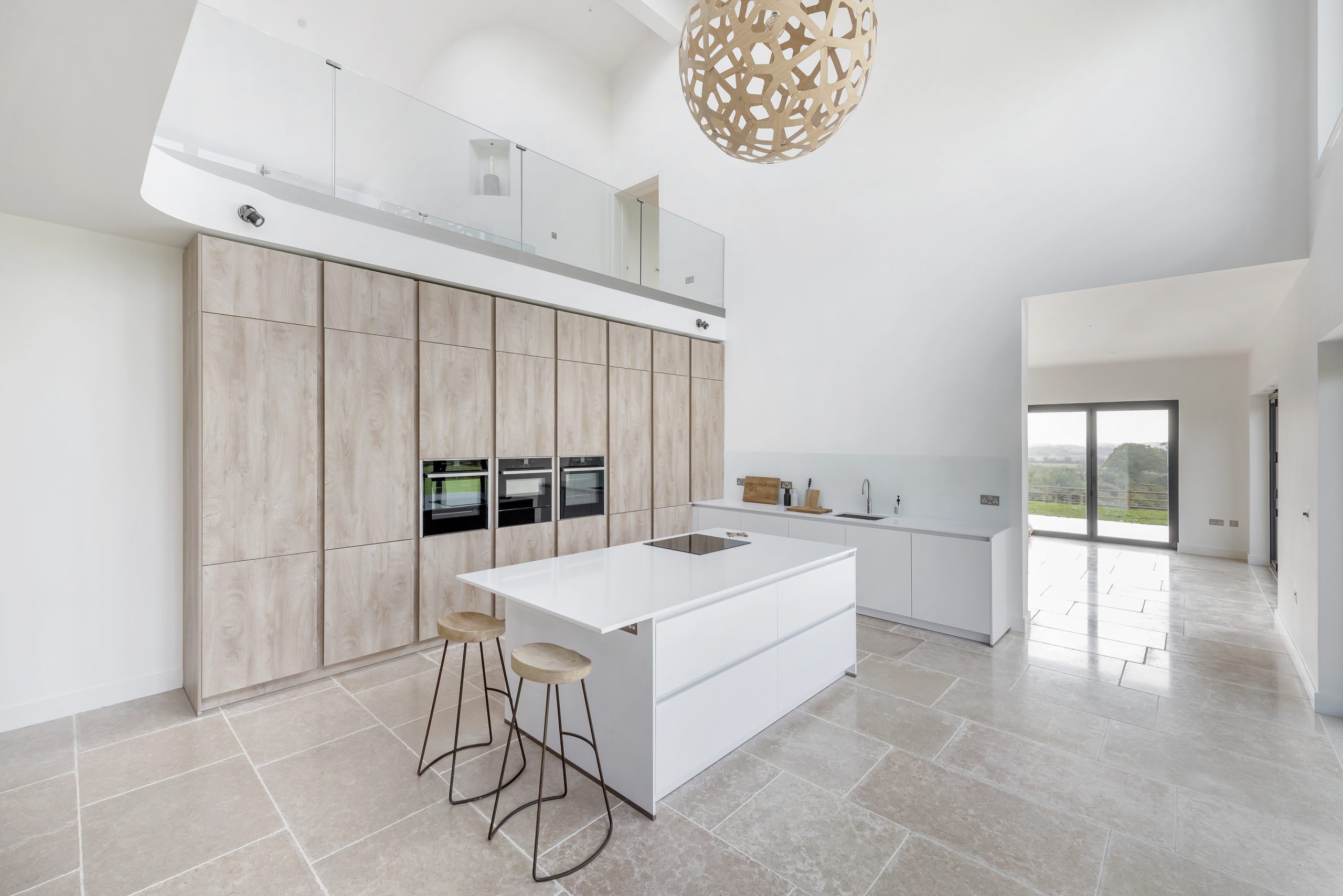 Minimalism Meets High Functionality in Open-Plan Kitchen Design